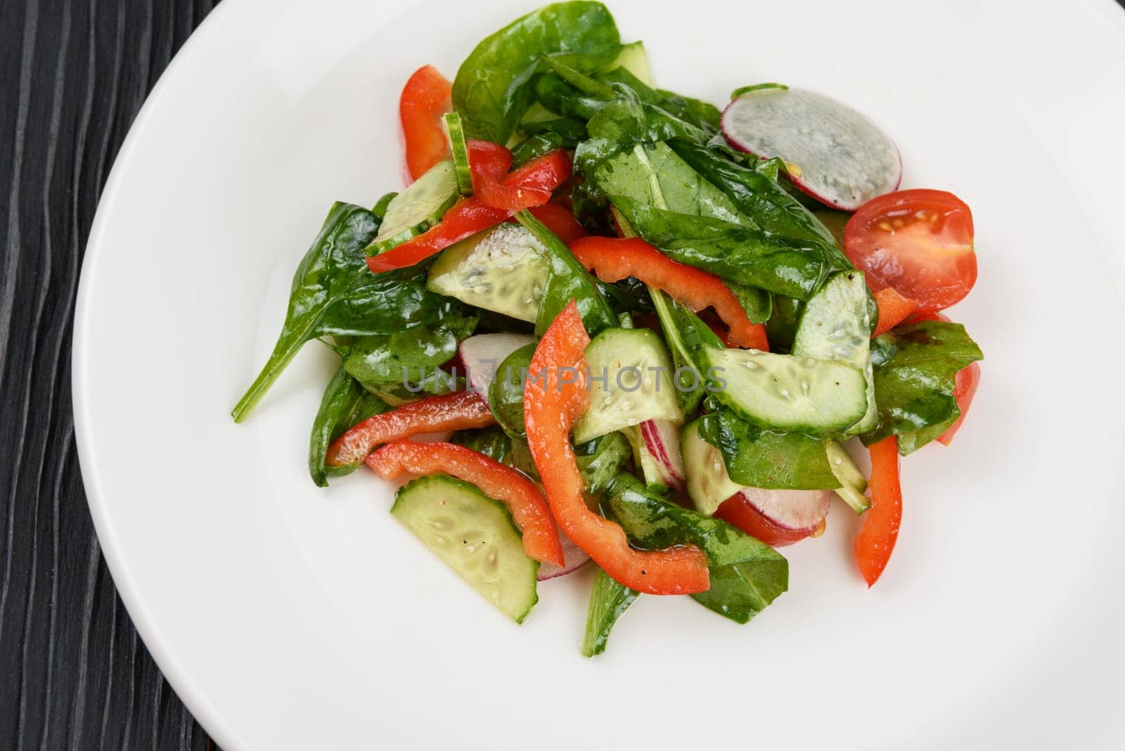 Vegetable vegetarian salad on white plate, closeup