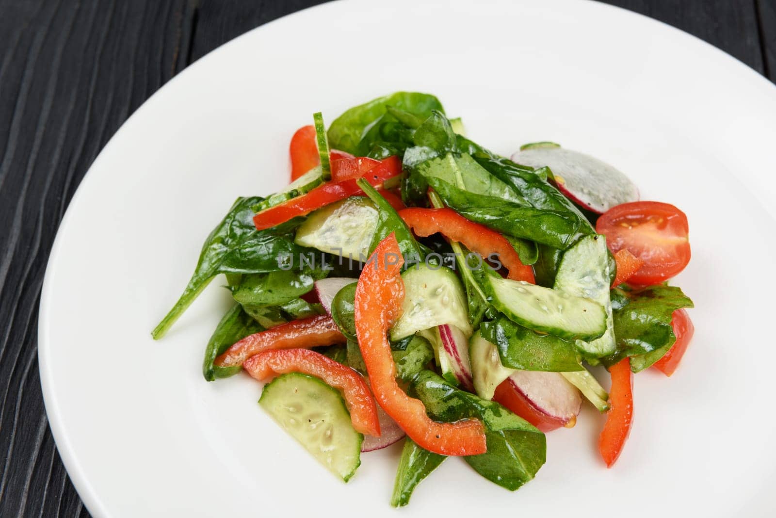 Vegetable vegetarian salad on white plate, closeup