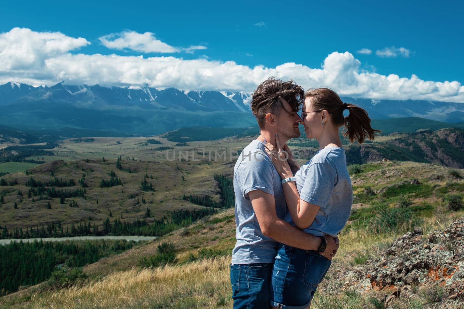Loving couple together on Altai mountain looking at a view