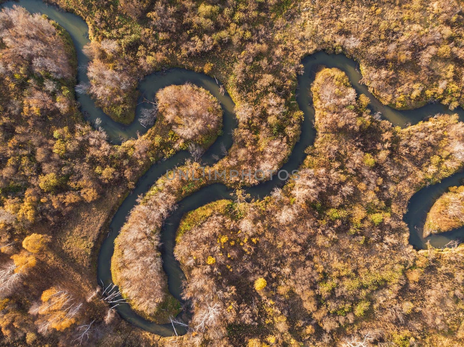 Aerial drone view of autumn landscape with river.