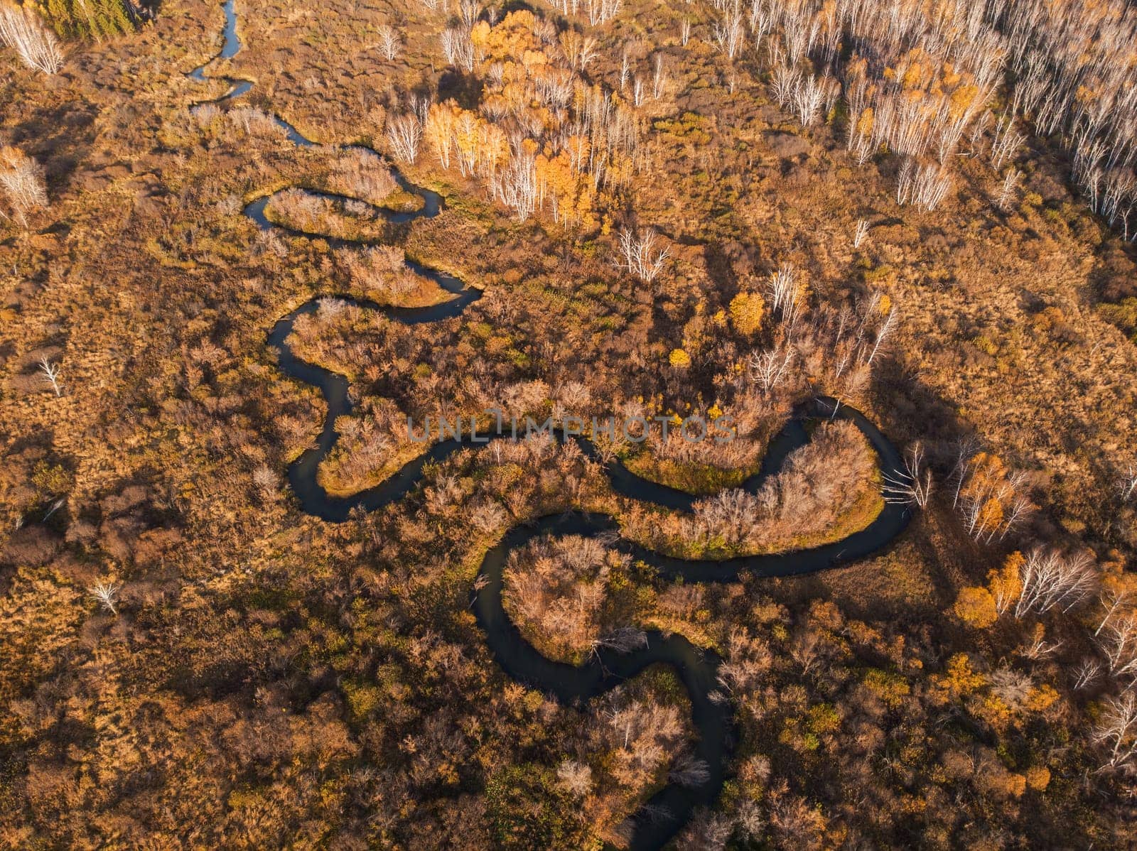 Aerial drone view of autumn landscape with river.