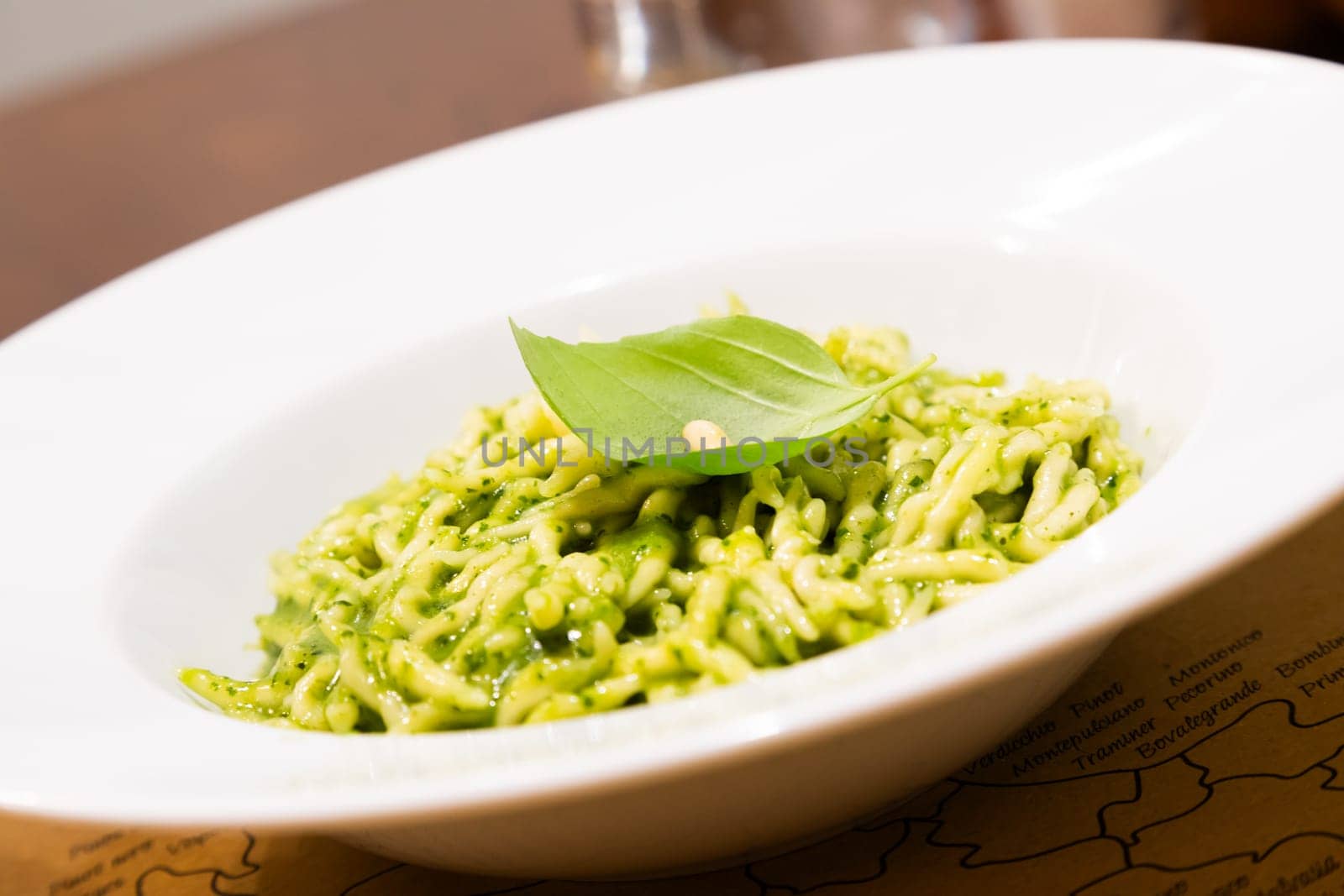 Traditional Italian food - trofie al pesto, typical regional pasta from Liguria region, with basil sauce