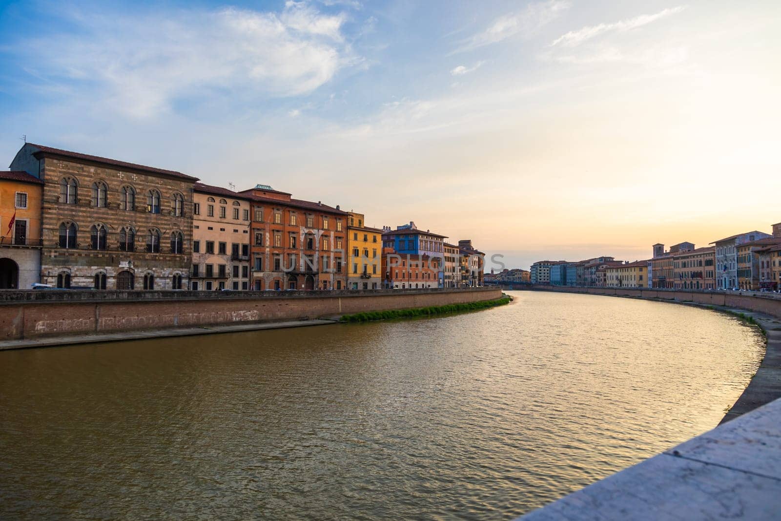 Pisa, Italy - 30 April 2024. The view of Arno river at sunset. Skyline cityscape.