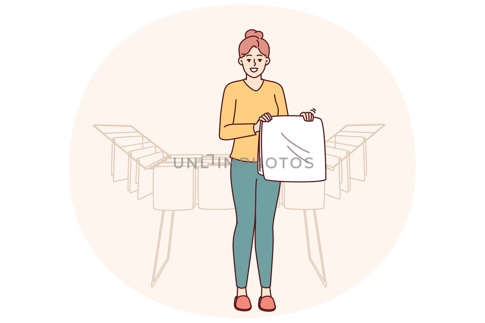 Woman housewife stands near dryer with clean towels doing household chores to create comfort in apartment. Housewife girl with washed item for advertising washing powder or aromatic laundry gel