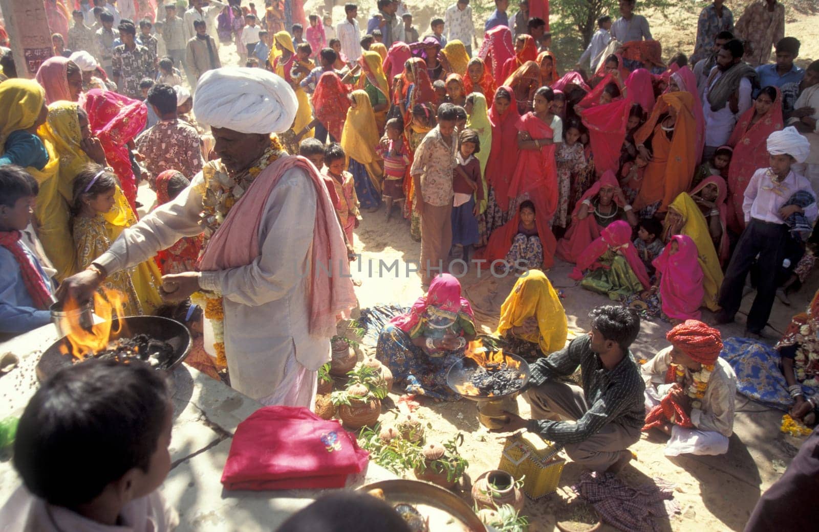Traditional dresst Rajasthani People on the way home after a traditional Funeral in the Town of Pushkar in the Province of Rajasthan in India.  India, Pushkar, January, 1998