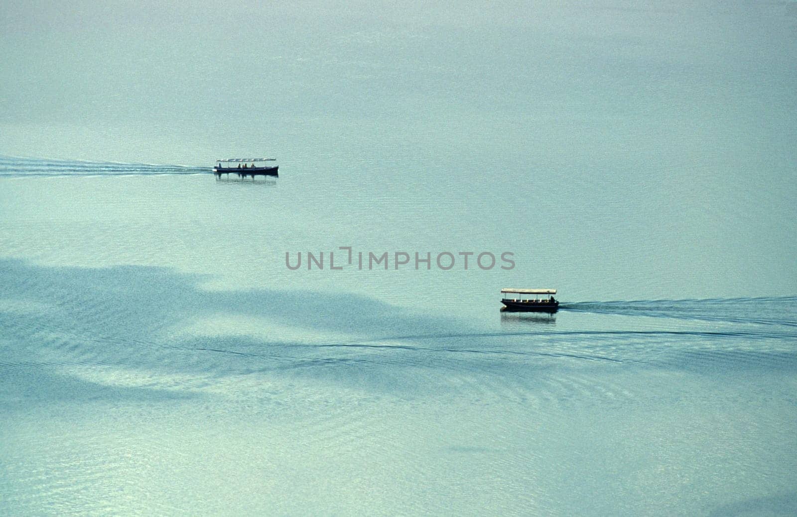 two boats on the Pichhola Lake in the Town of Udaipur in the Province of Rajasthan in India.  India, Udaipur, January, 1998