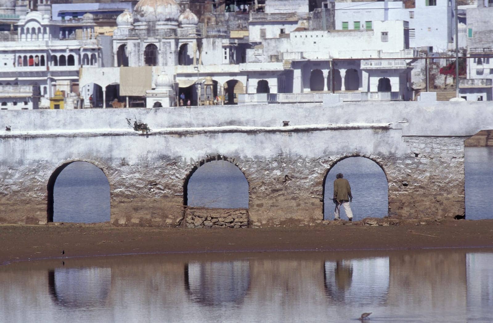 Architectur with Palace and Houses on the Pichhola Lake in the Town of Udaipur in the Province of Rajasthan in India.  India, Udaipur, January, 1998