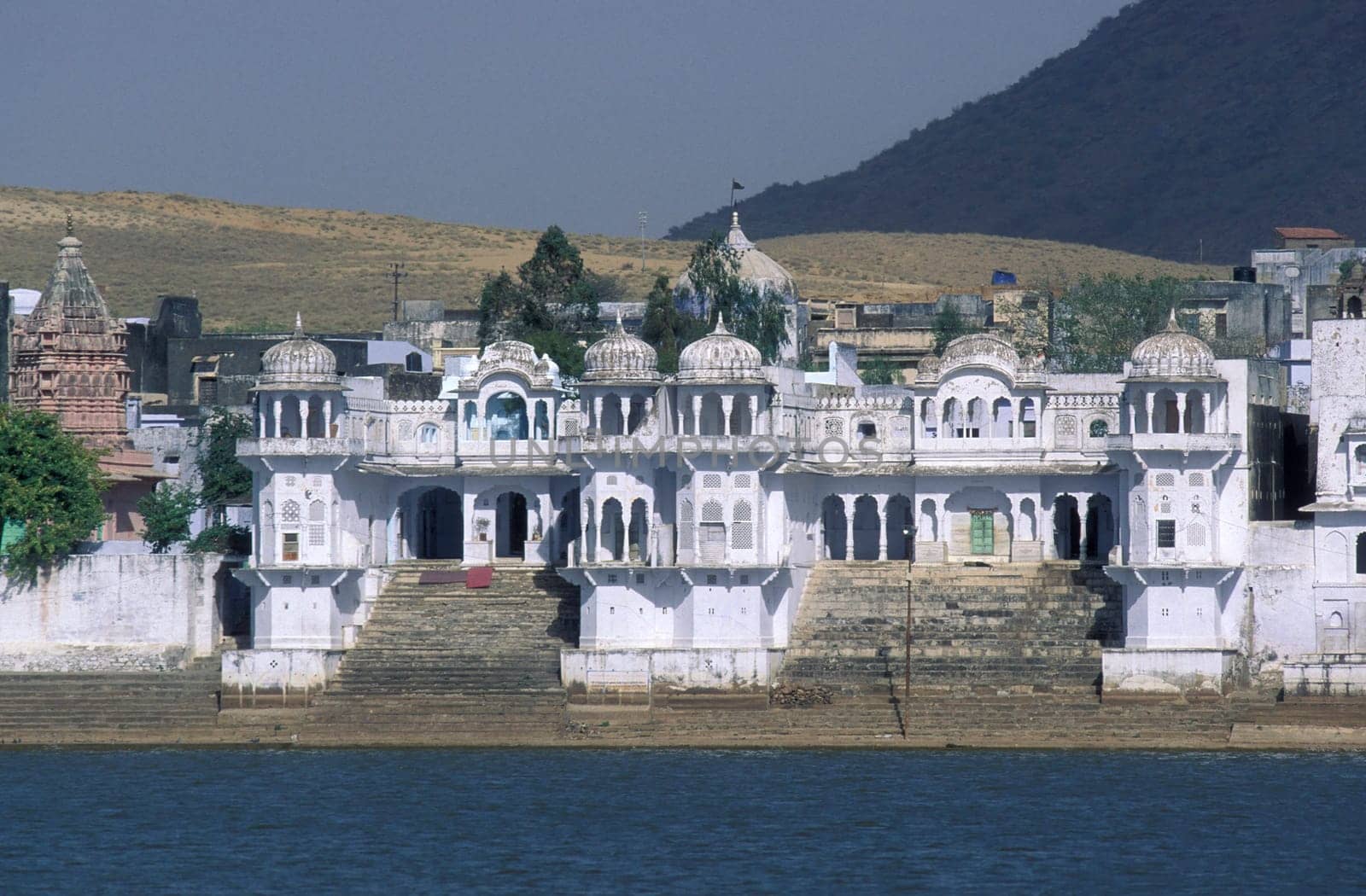 Architectur with Palace and Houses on the Pichhola Lake in the Town of Udaipur in the Province of Rajasthan in India.  India, Udaipur, January, 1998