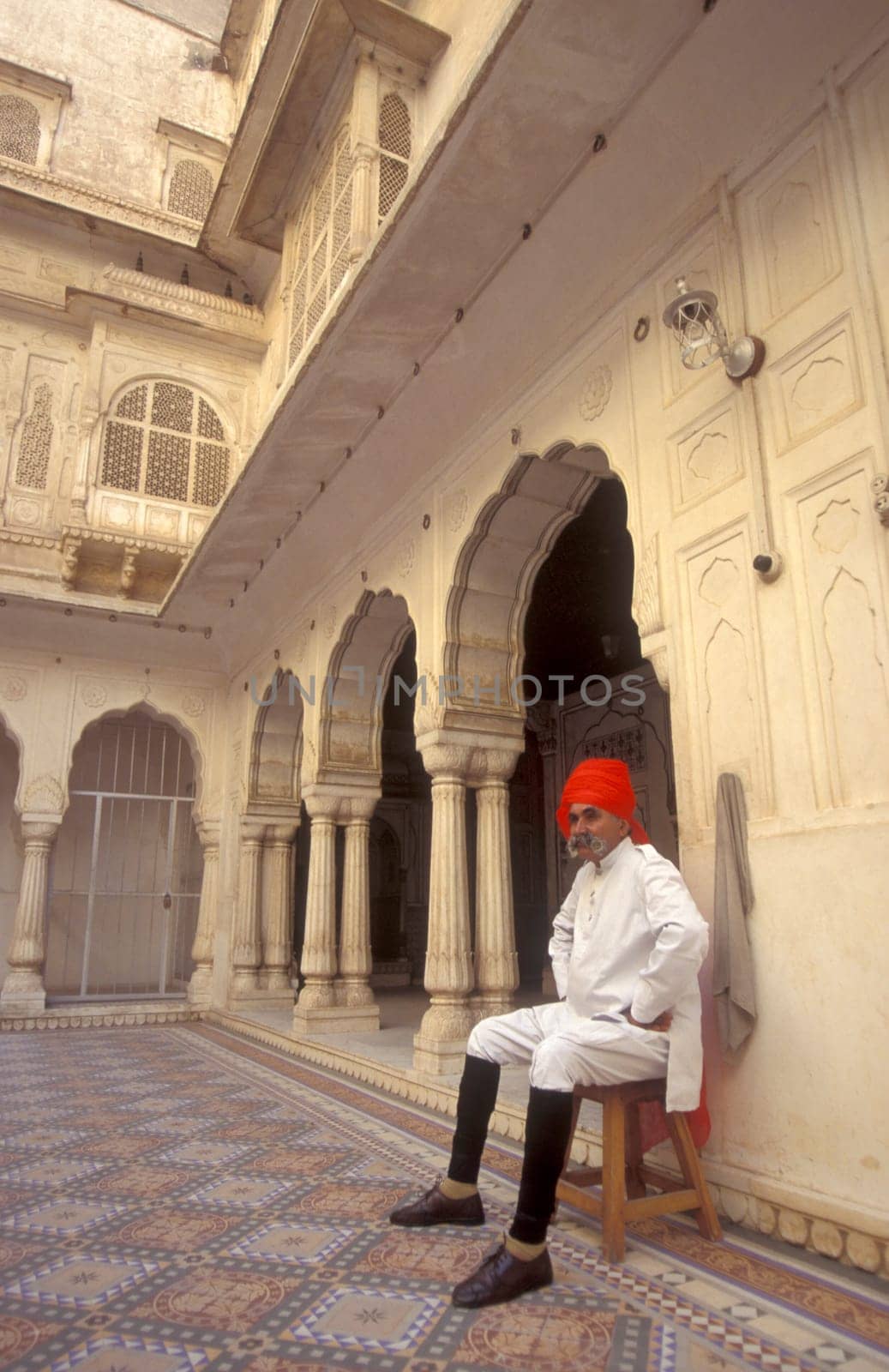 a Rajasthani men in traditional dress at the City Palace Hotel in the Town of Udaipur in the Province of Rajasthan in India.  India, Udaipur, January, 1998