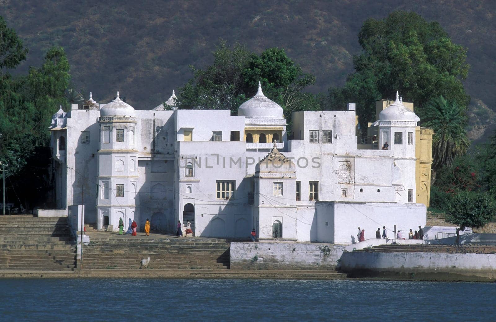 Architectur with Palace and Houses on the Pichhola Lake in the Town of Udaipur in the Province of Rajasthan in India.  India, Udaipur, January, 1998