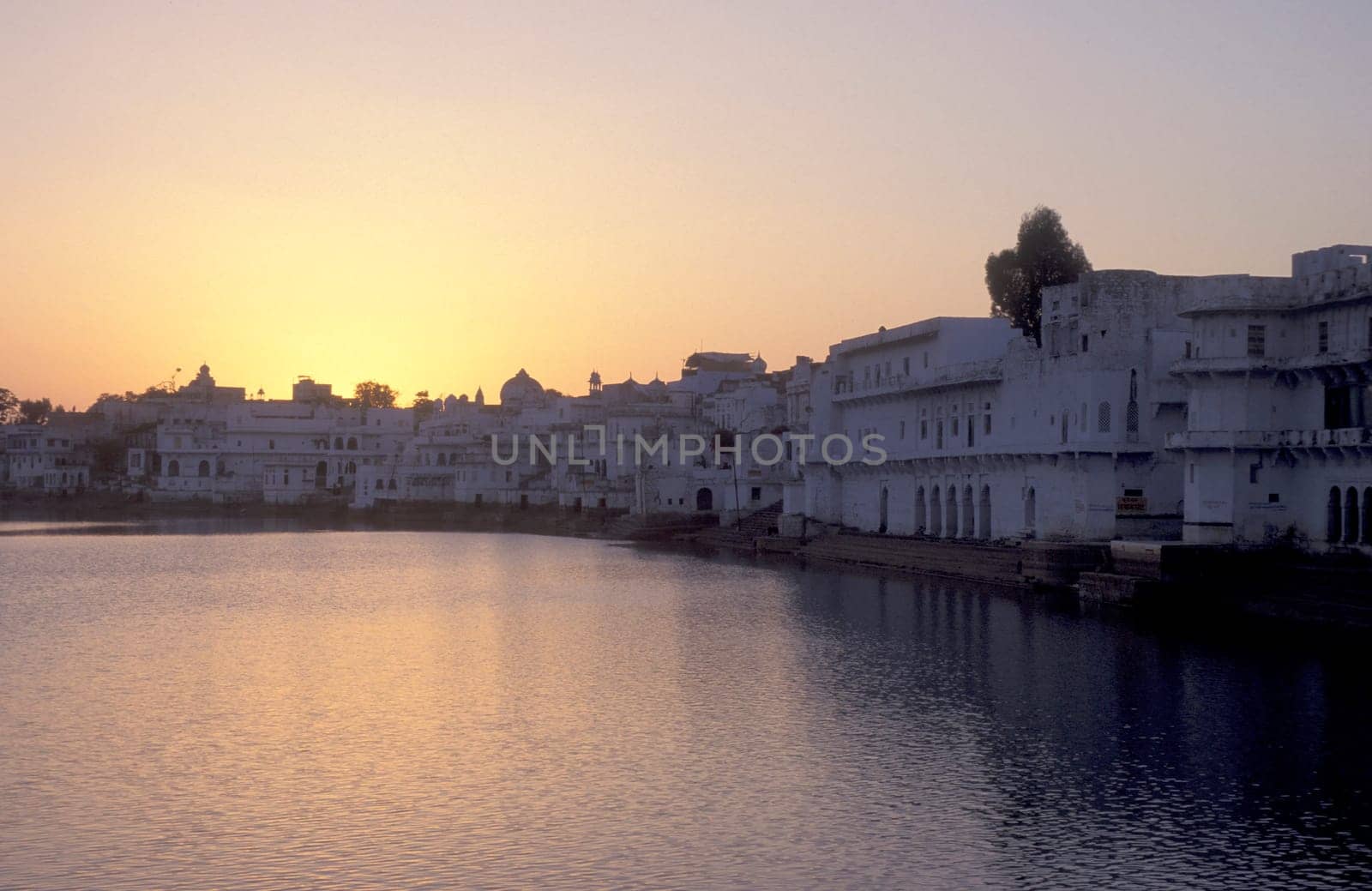 Architectur with Palace and Houses on the Pichhola Lake in the Town of Udaipur in the Province of Rajasthan in India.  India, Udaipur, January, 1998