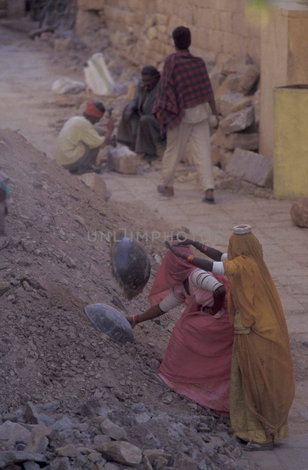 two Rajasthani women at a construction work in the Town of Jaisalmer in the Province of Rajasthan in India.  India, Jaisalmer, January, 1998