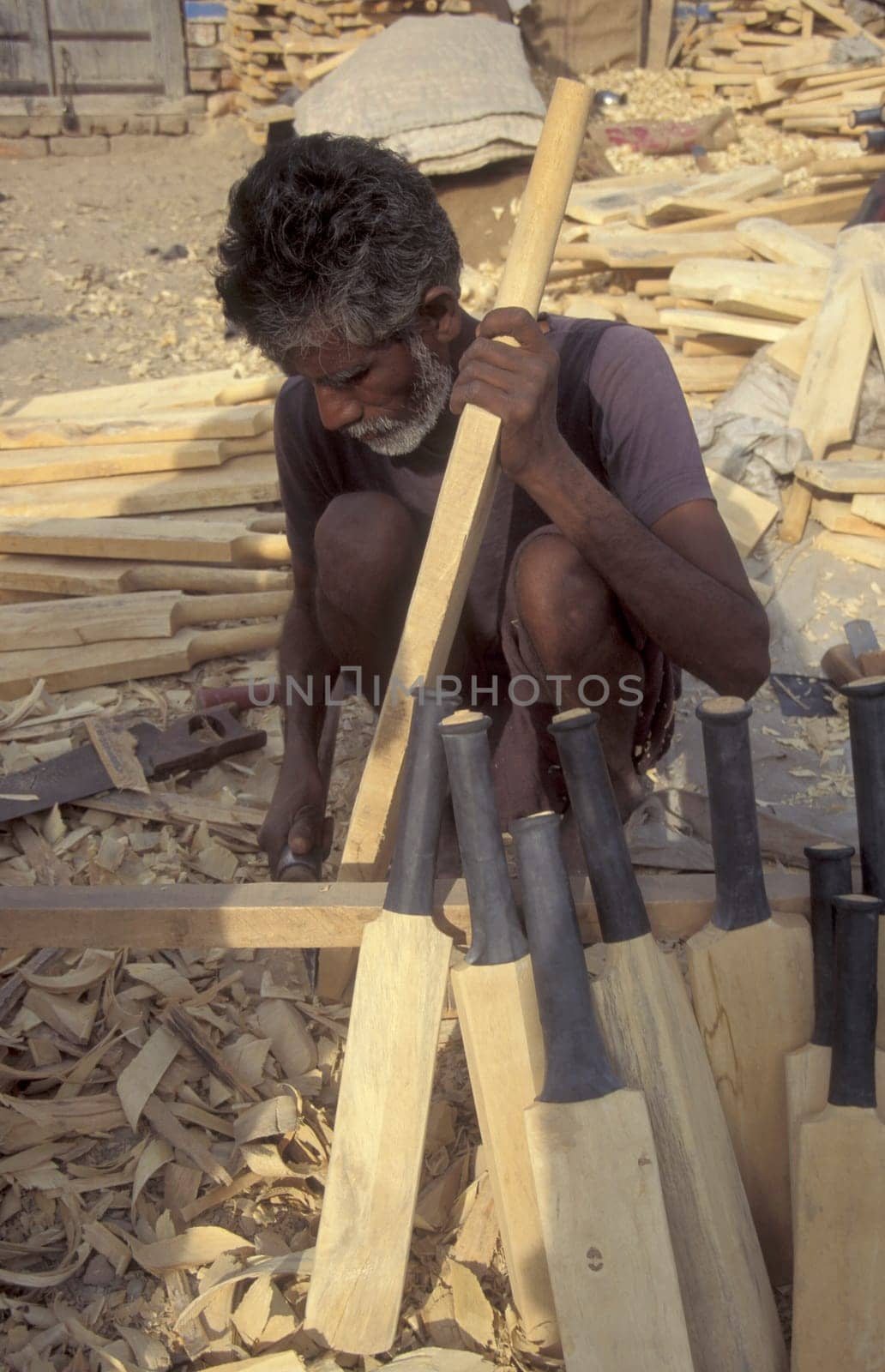a men is carve Cricket Bats in the Town of Jaisalmer in the Province of Rajasthan in India.  India, Jaisalmer, January, 1998