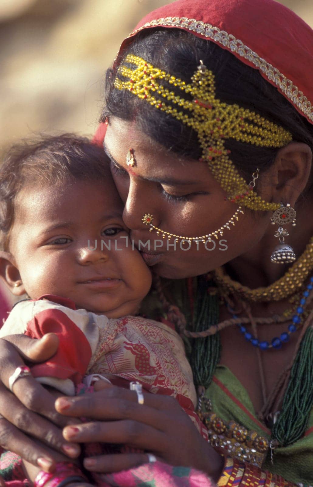 a portrait of a Rajasthani women with her Baby in the Town of Jaisalmer in the Province of Rajasthan in India.  India, Jaisalmer, January, 1998
