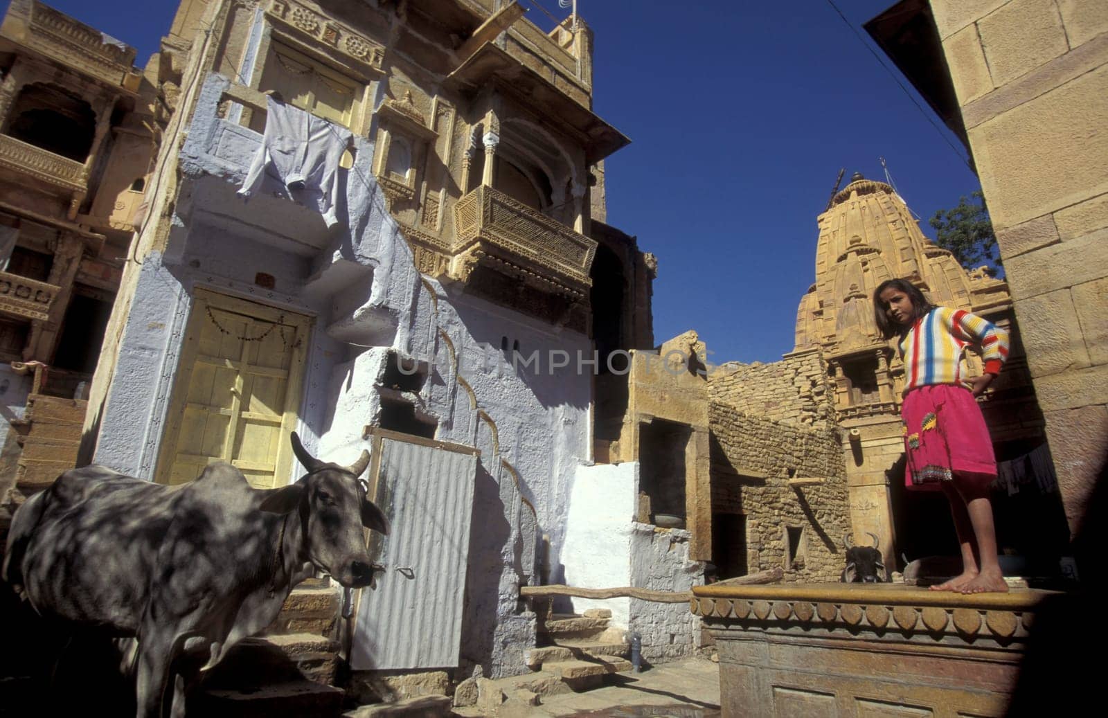 a Child is playing in the old Town in the Jaisalmer Fort with the city of Jaisalmer in the Province of Rajasthan in India.  India, Jaisalmer, January, 1998
