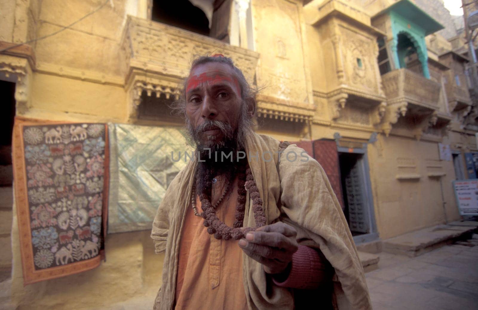 a street Sadhu in the old Town in the Jaisalmer Fort with the city of Jaisalmer in the Province of Rajasthan in India.  India, Jaisalmer, January, 1998