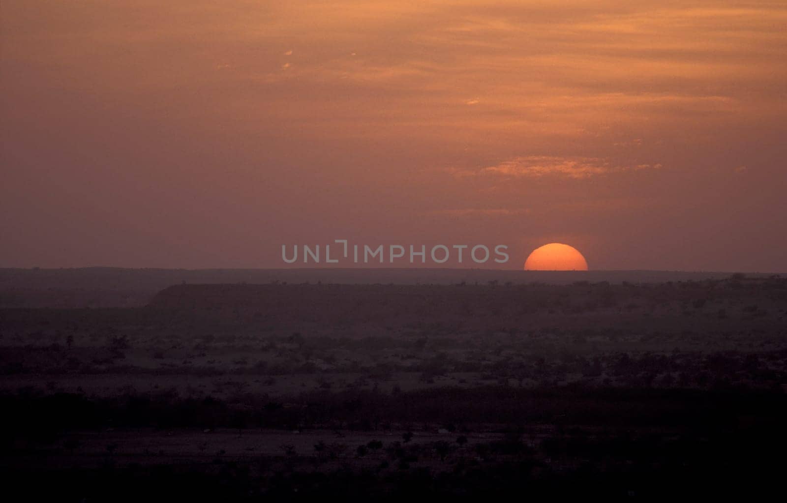 a sunset in the Thar Desert near the Town of Jaisalmer in the Province of Rajasthan in India.  India, Jaisalmer, January, 1998