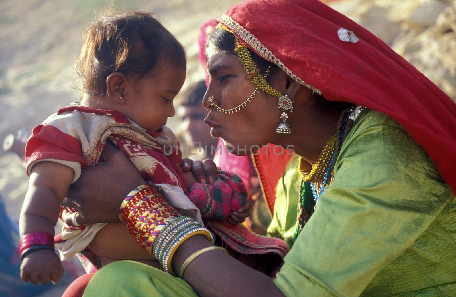 a portrait of a Rajasthani women with her Baby in the Town of Jaisalmer in the Province of Rajasthan in India.  India, Jaisalmer, January, 1998