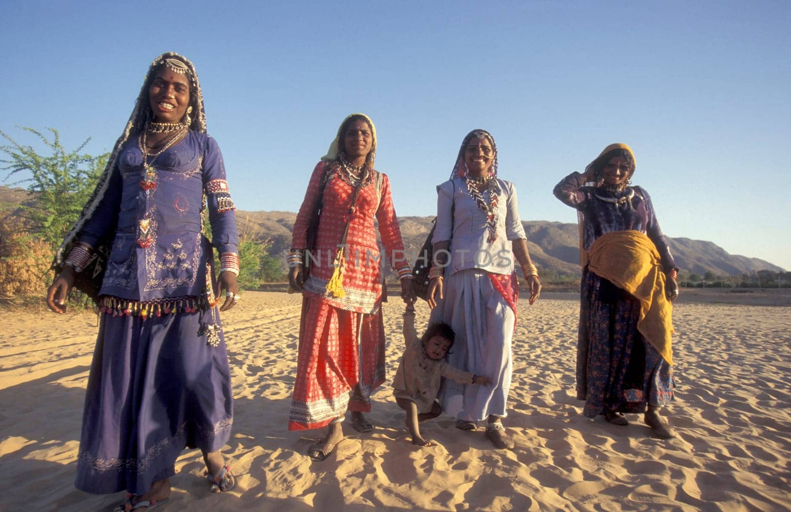 a portrait of a Rajasthani women with her Baby in the Town of Jaisalmer in the Province of Rajasthan in India.  India, Jaisalmer, January, 1998