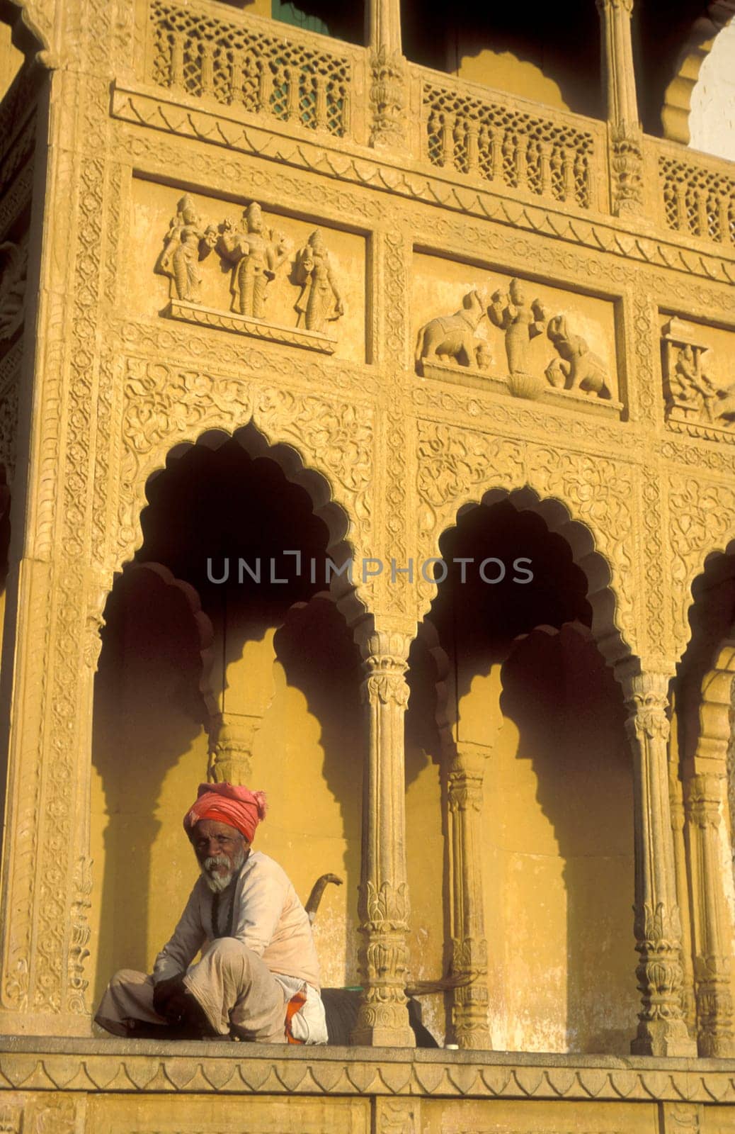 a men at the entry of the old Rangji Temple in the Town of Pushkar in the Province of Rajasthan in India.  India, Pushkar, January, 1998