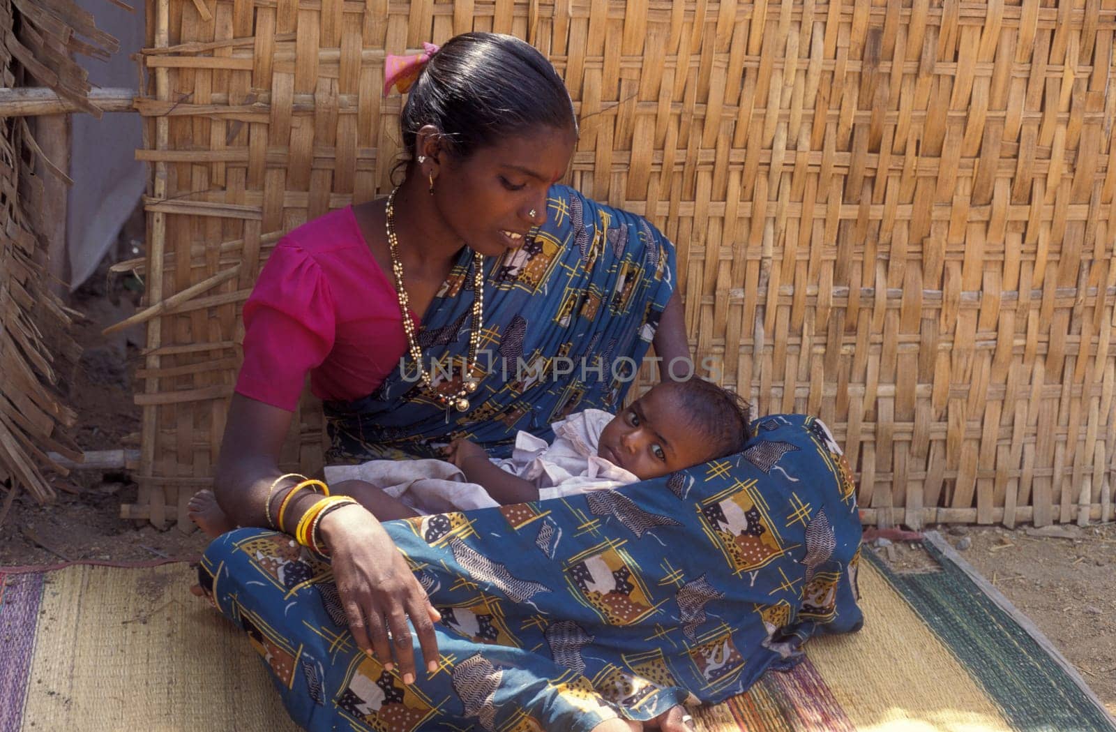 a portrait of a Rajasthani women with her Baby in the Town of Jaisalmer in the Province of Rajasthan in India.  India, Jaisalmer, January, 1998
