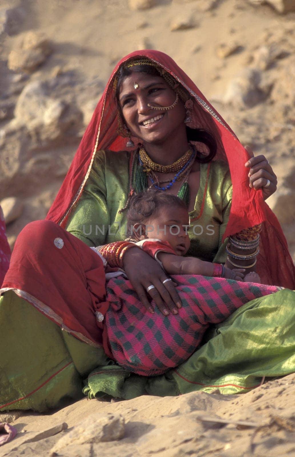 a portrait of a Rajasthani women with her Baby in the Town of Jaisalmer in the Province of Rajasthan in India.  India, Jaisalmer, January, 1998
