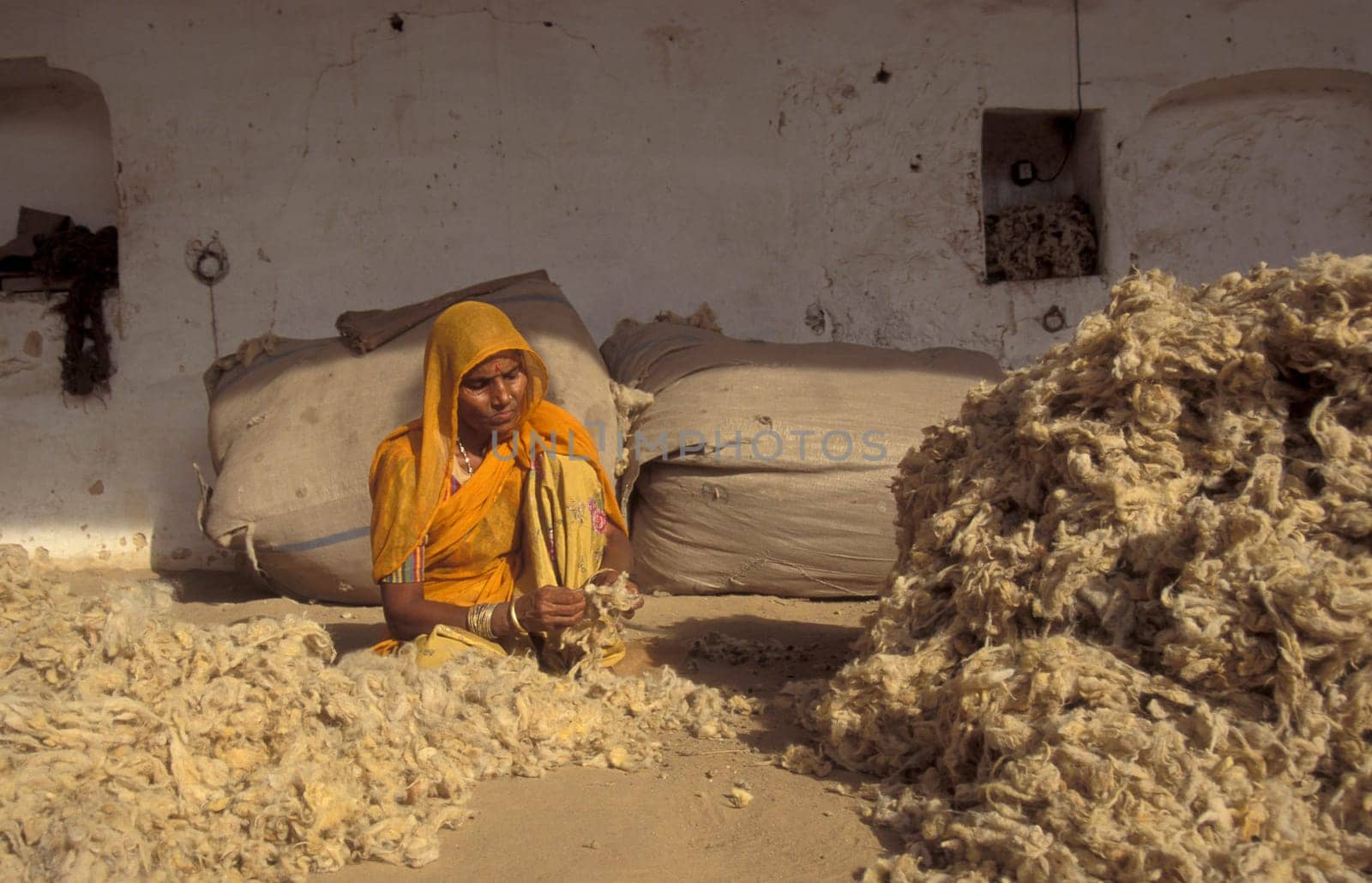 Working People in a Camel wool spinning Factory in the City of Jaisalmer in the Province of Rajasthan in India.  India, Jaisalmer, January, 1998