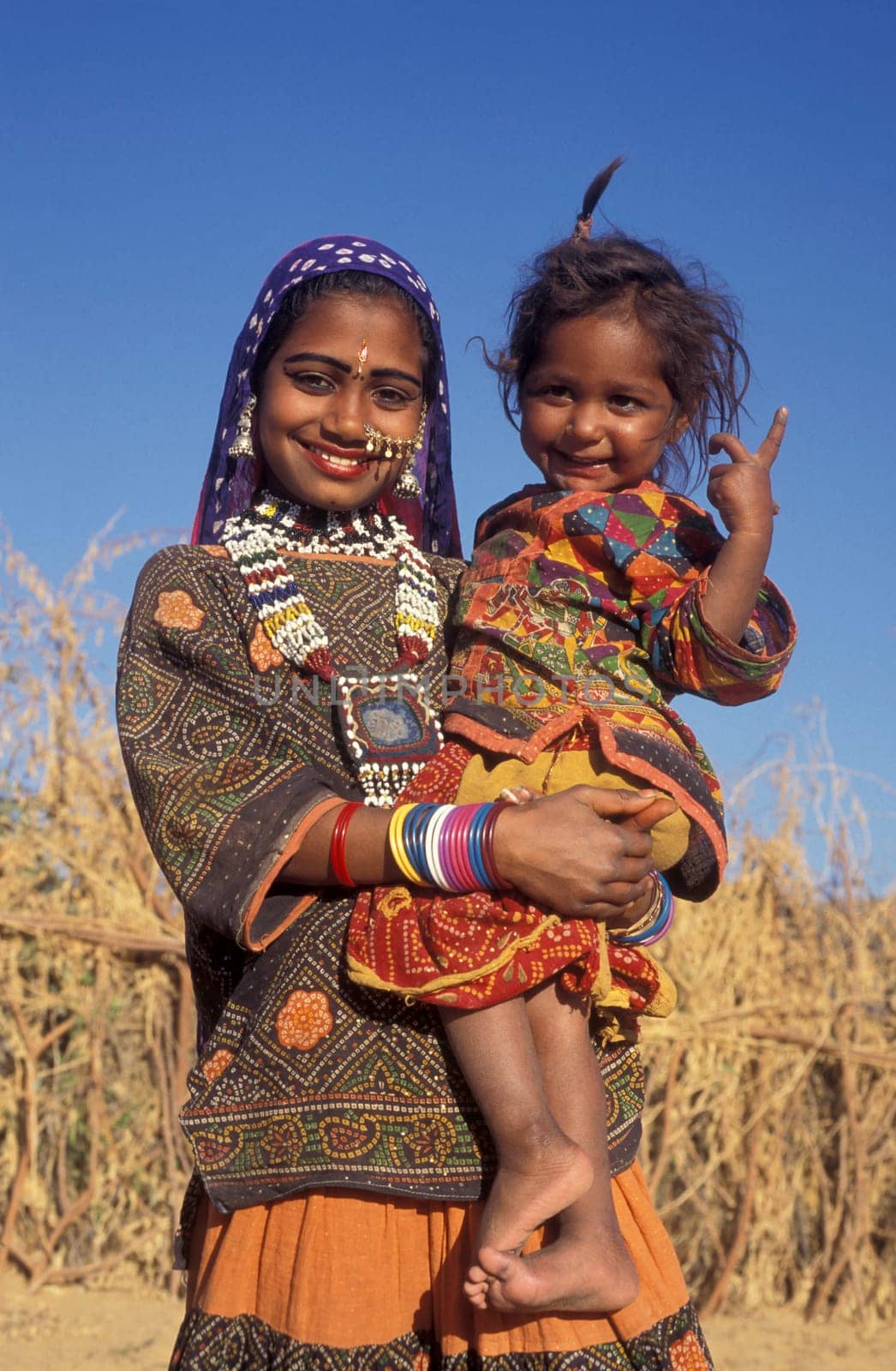 a portrait of a Rajasthani women with her Baby in the Town of Jaisalmer in the Province of Rajasthan in India.  India, Jaisalmer, January, 1998