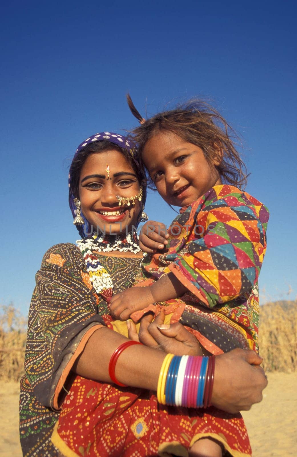 a portrait of a Rajasthani women with her Baby in the Town of Jaisalmer in the Province of Rajasthan in India.  India, Jaisalmer, January, 1998