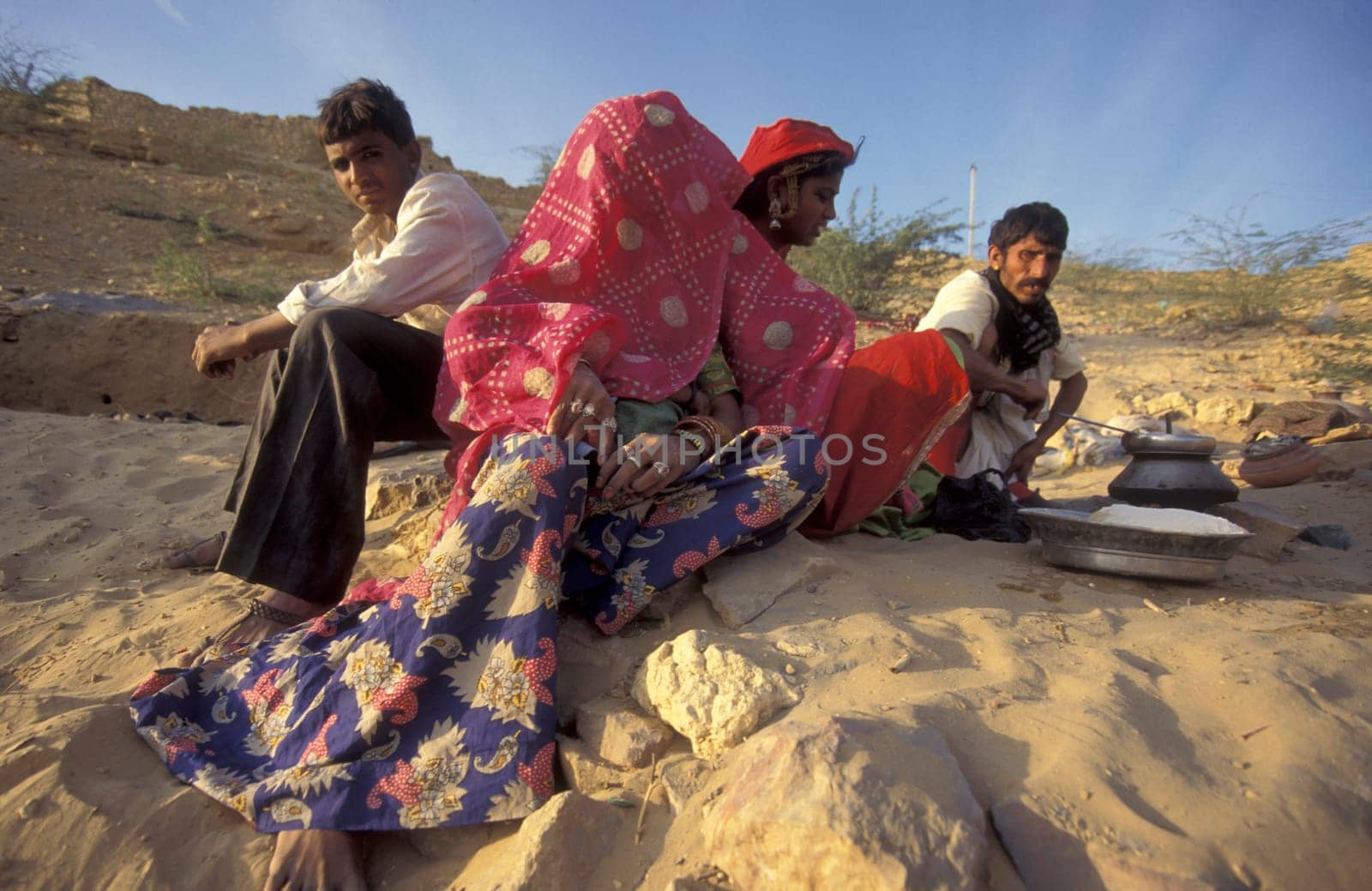 a Rajasthani women is cocking on a fire with her Baby in the Town of Jaisalmer in the Province of Rajasthan in India.  India, Jaisalmer, January, 1998