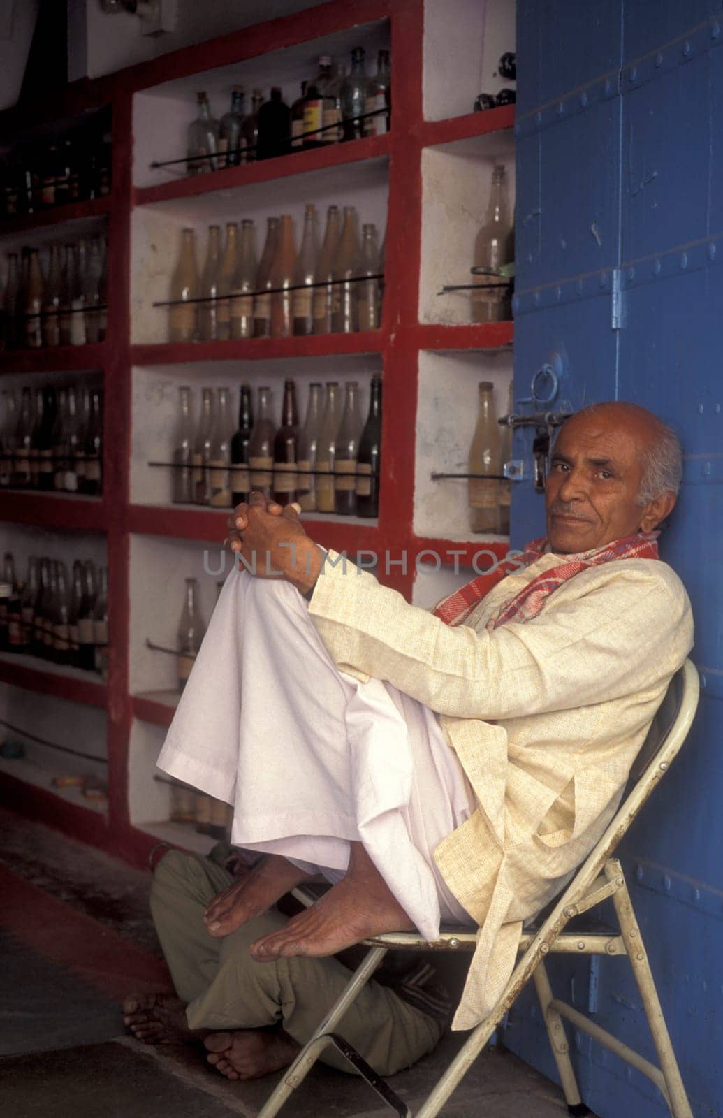A Indian Doctor at his Drugstore and Madicine Shop at a market in the Town of Jaisalmer in the Province of Rajasthan in India.  India, Jaisalmer, January, 1998