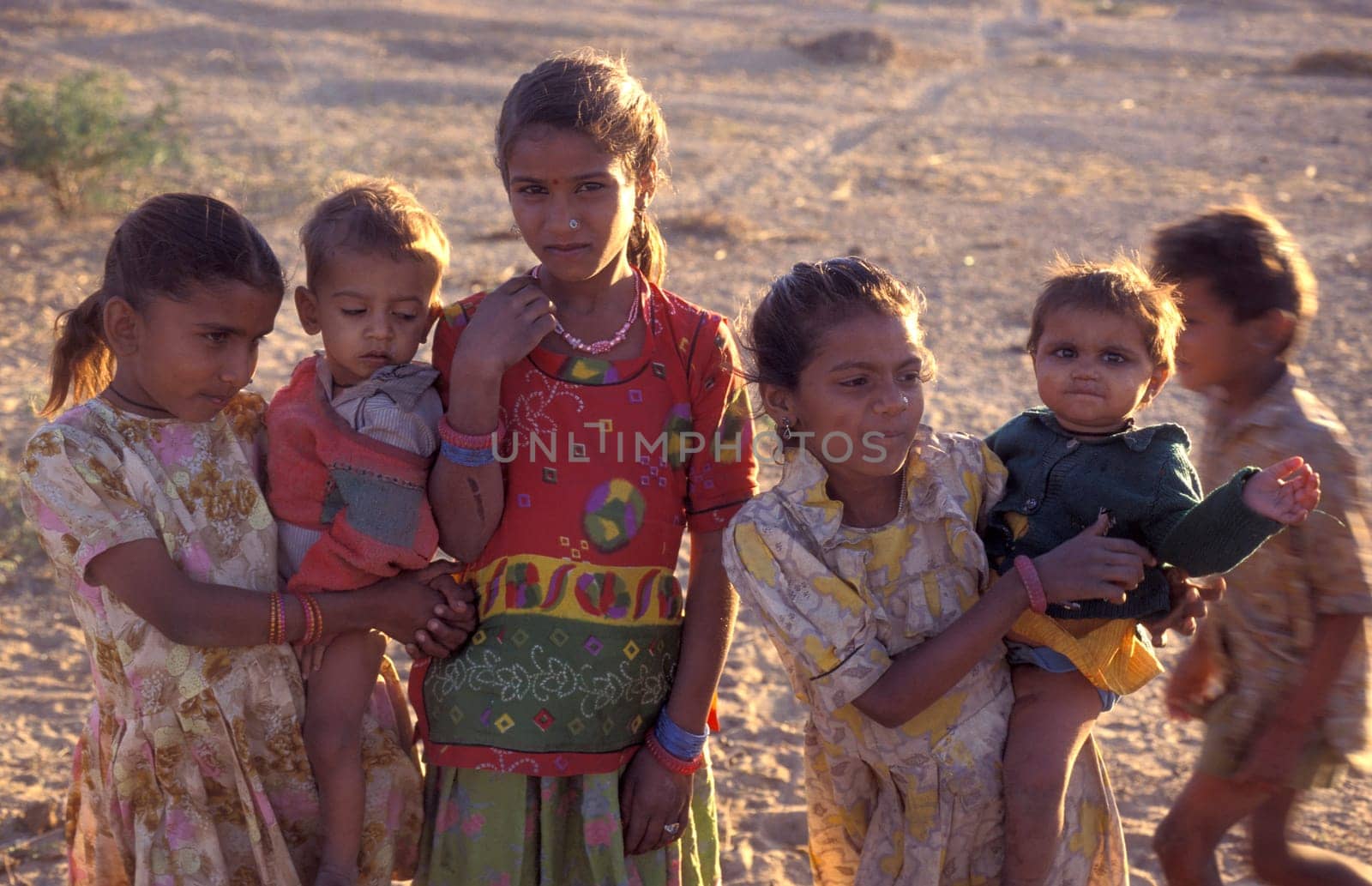 a group of Rajasthani children posing in the Town of Jaisalmer in the Province of Rajasthan in India.  India, Jaisalmer, January, 1998