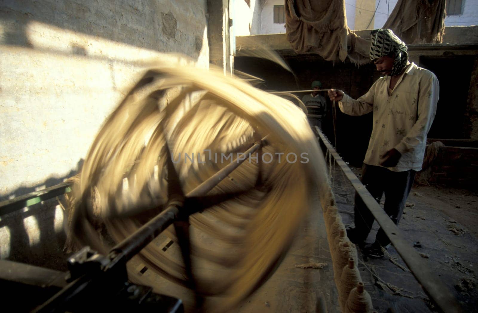 Working People in a Camel wool spinning Factory in the City of Jaisalmer in the Province of Rajasthan in India.  India, Jaisalmer, January, 1998