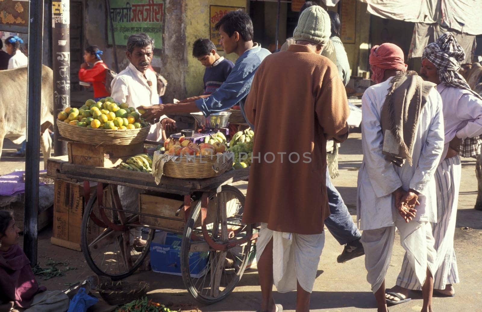 a street and foodmarket in the Town of Jaisalmer in the Province of Rajasthan in India.  India, Jaisalmer, January, 1998