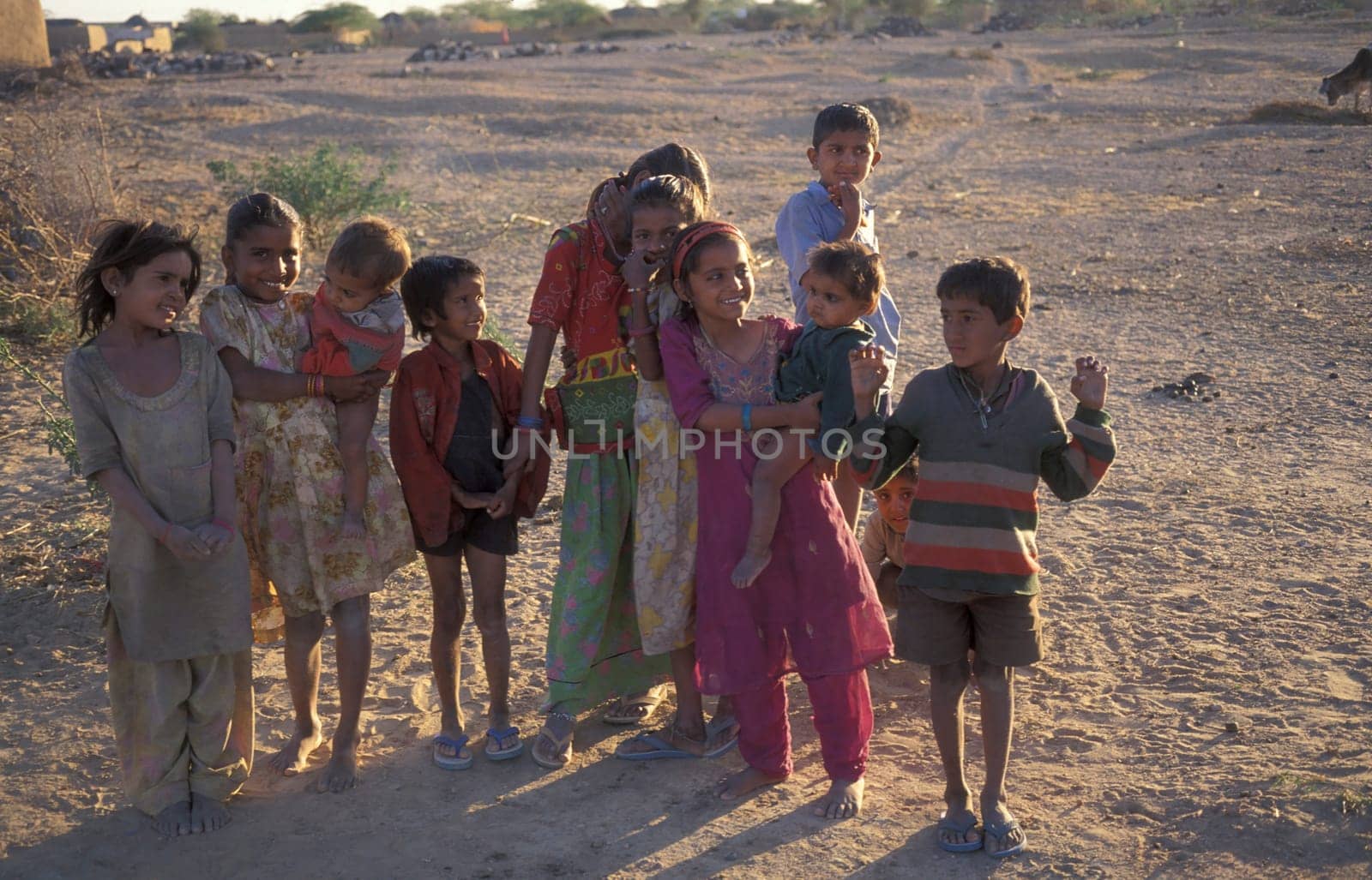 a group of Rajasthani children posing in the Town of Jaisalmer in the Province of Rajasthan in India.  India, Jaisalmer, January, 1998