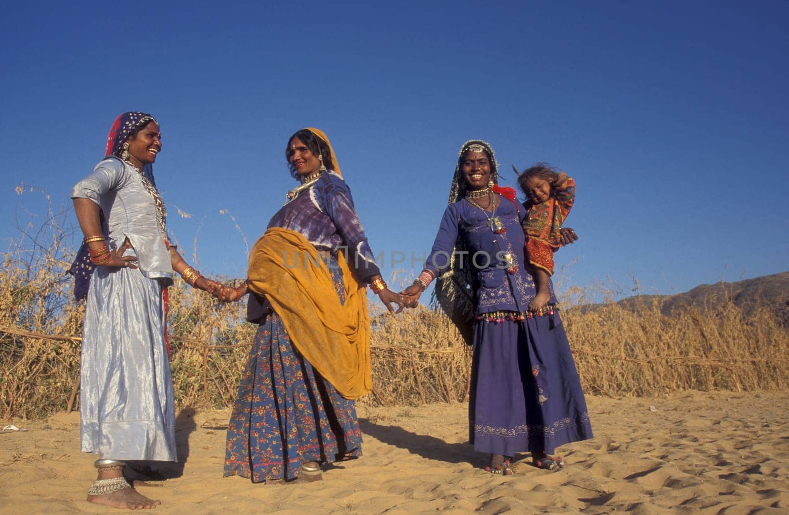 a portrait of a Rajasthani women with her Baby in the Town of Jaisalmer in the Province of Rajasthan in India.  India, Jaisalmer, January, 1998