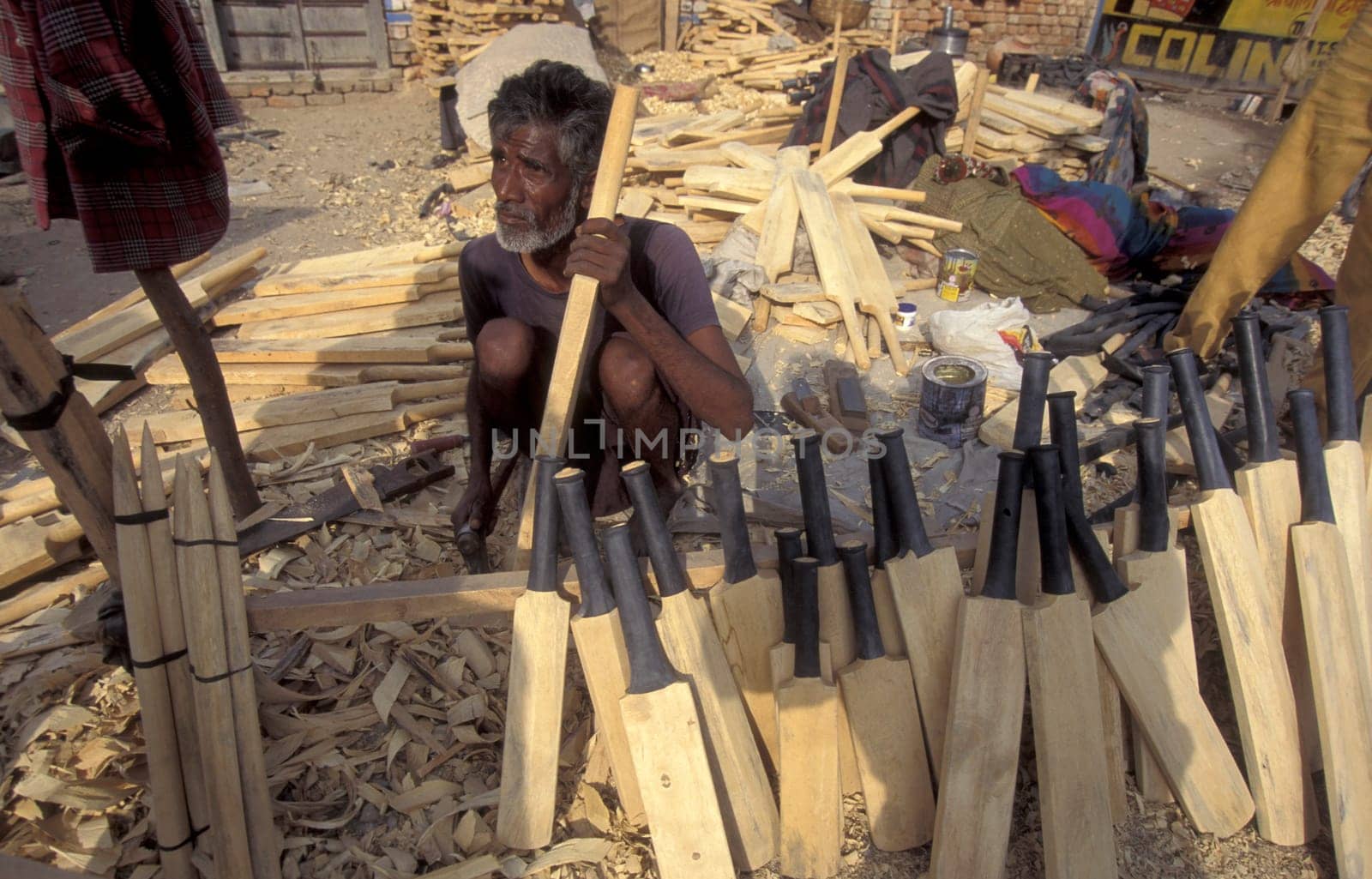 a men carving new wood cricket Bat at a Factory in the City of Jaisalmer in the Province of Rajasthan in India.  India, Jaisalmer, January, 1998