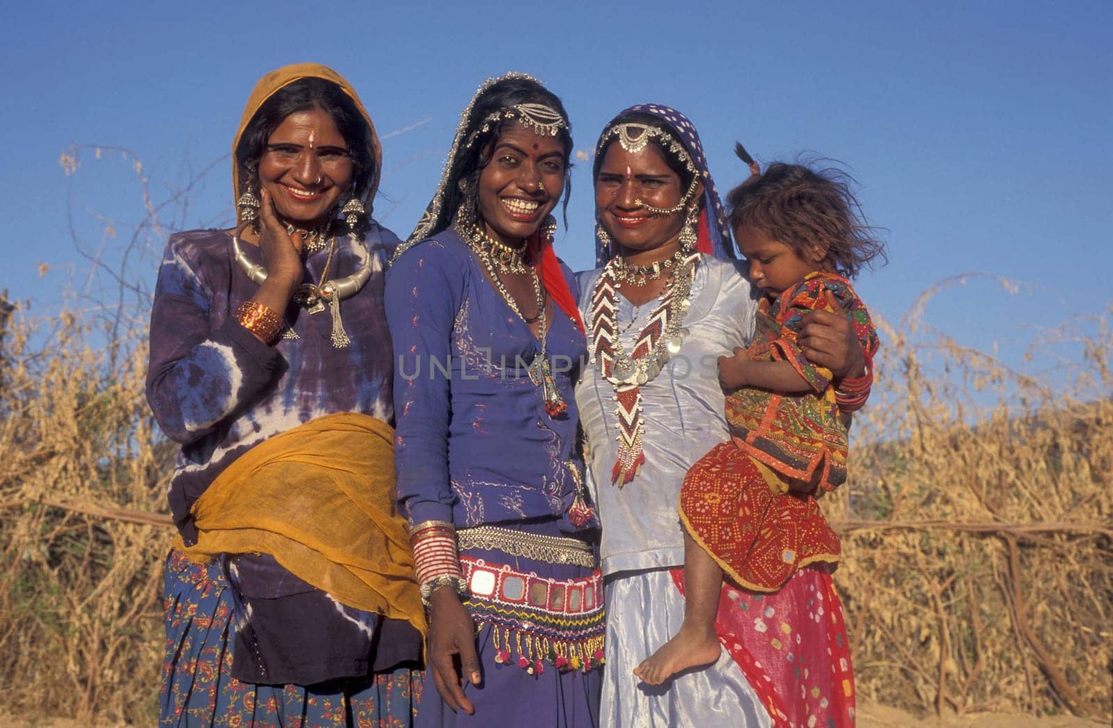 a portrait of a Rajasthani women with her Baby in the Town of Jaisalmer in the Province of Rajasthan in India.  India, Jaisalmer, January, 1998