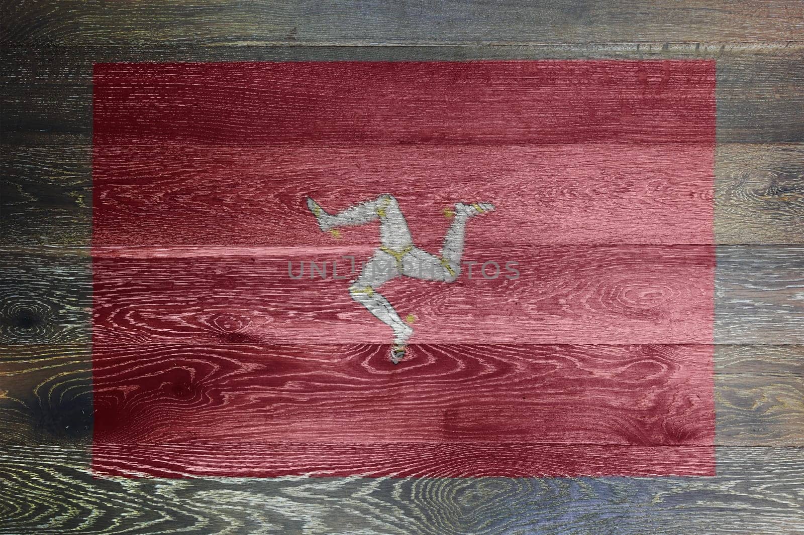 An Isle of man flag on rustic old wood surface background