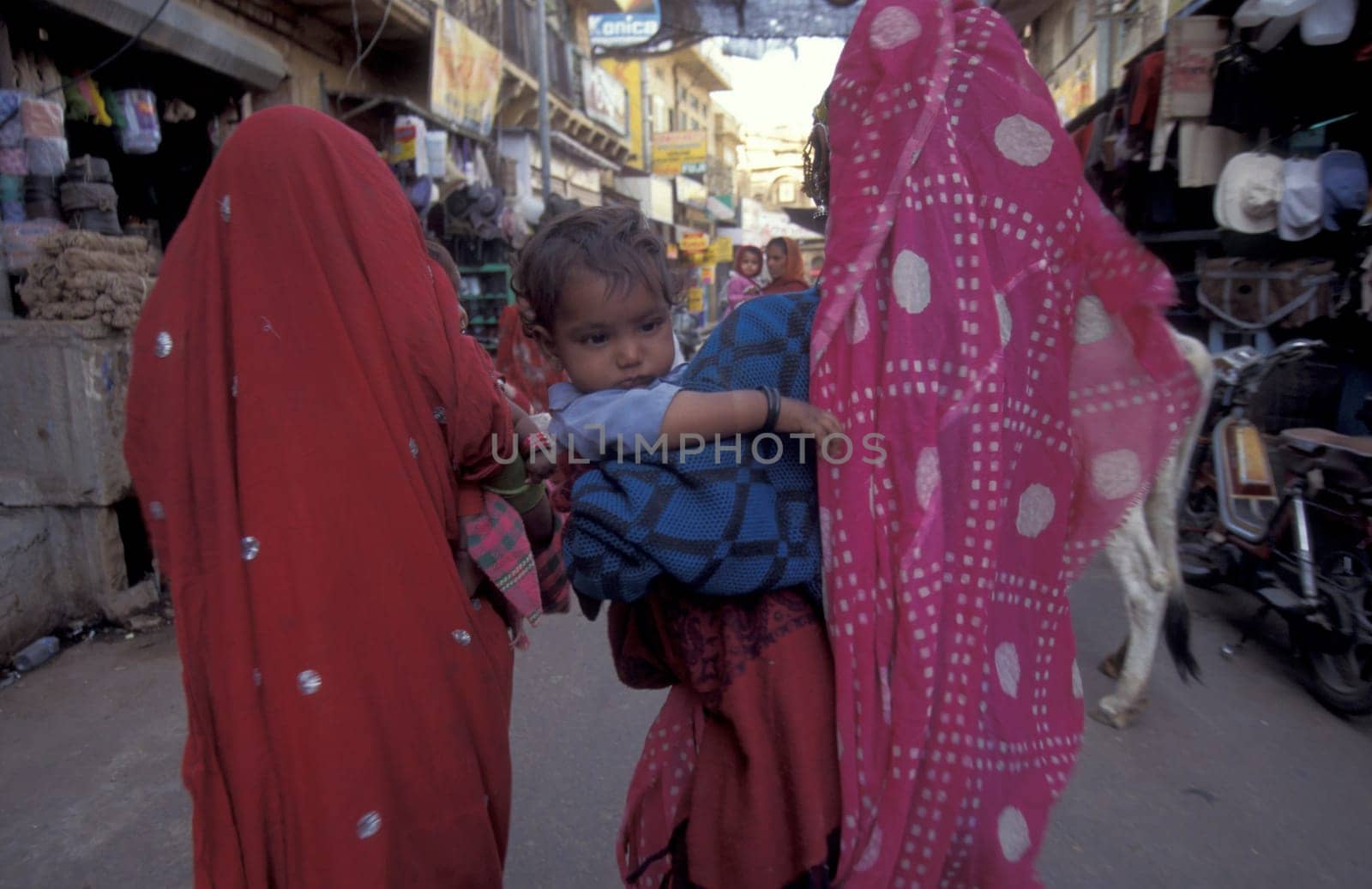 a Rajasthani women with her Baby in the Town of Jaisalmer in the Province of Rajasthan in India.  India, Jaisalmer, January, 1998