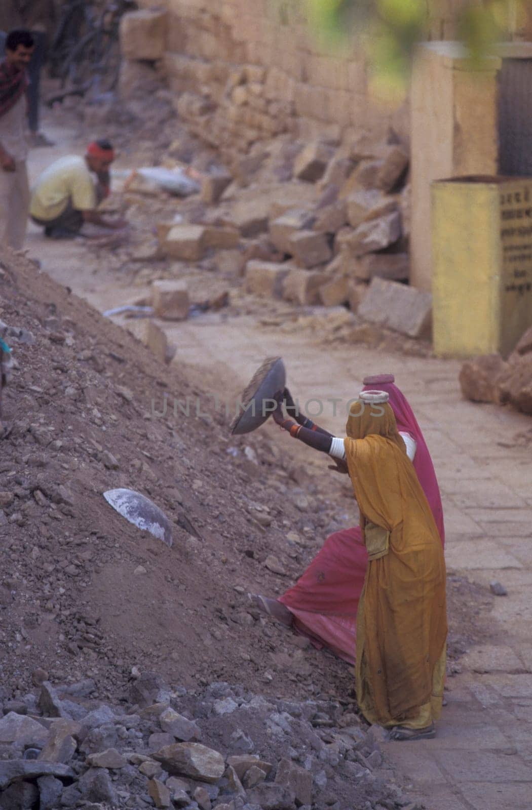 two Rajasthani women at a construction work in the Town of Jaisalmer in the Province of Rajasthan in India.  India, Jaisalmer, January, 1998