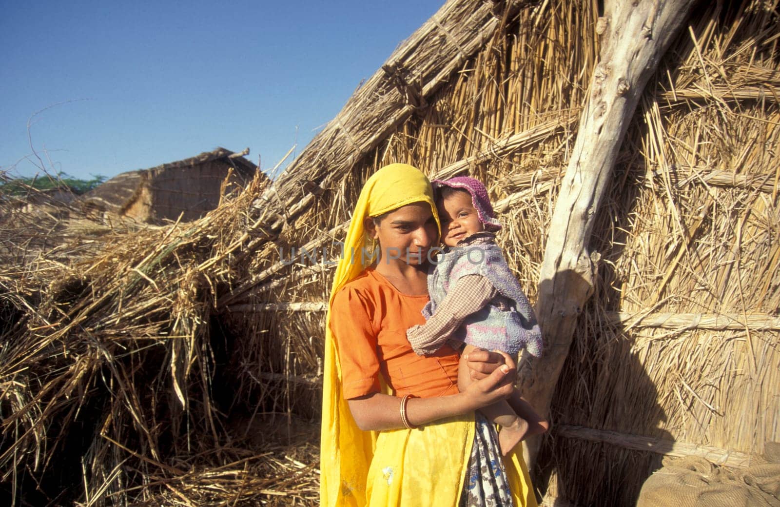 a portrait of a Rajasthani women with her Baby in the Town of Jaisalmer in the Province of Rajasthan in India.  India, Jaisalmer, January, 1998