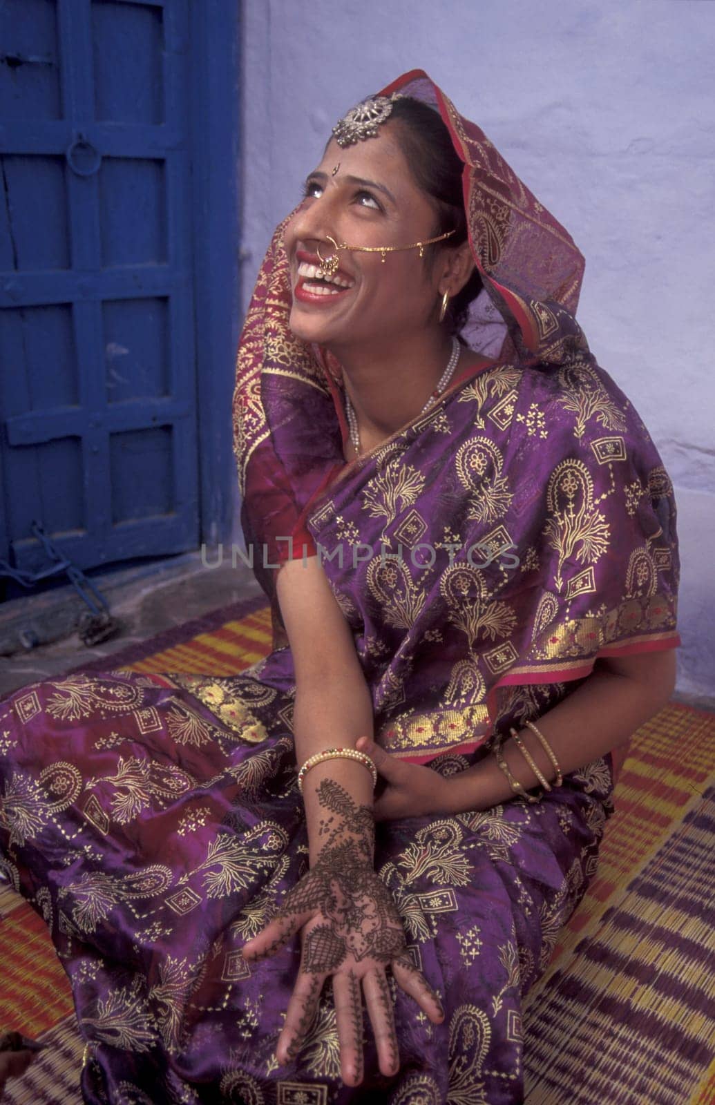 a Rajasthani women is making a Henna Hand painting in the Town of Jaisalmer in the Province of Rajasthan in India.  India, Jaisalmer, January, 1998