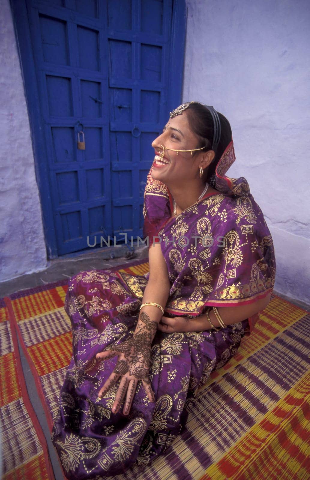 a Rajasthani women is making a Henna Hand painting in the Town of Jaisalmer in the Province of Rajasthan in India.  India, Jaisalmer, January, 1998