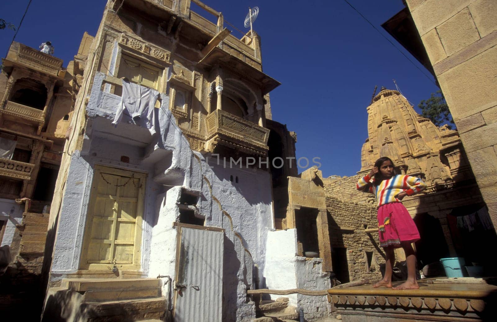 a Child is playing in the old Town in the Jaisalmer Fort with the city of Jaisalmer in the Province of Rajasthan in India.  India, Jaisalmer, January, 1998