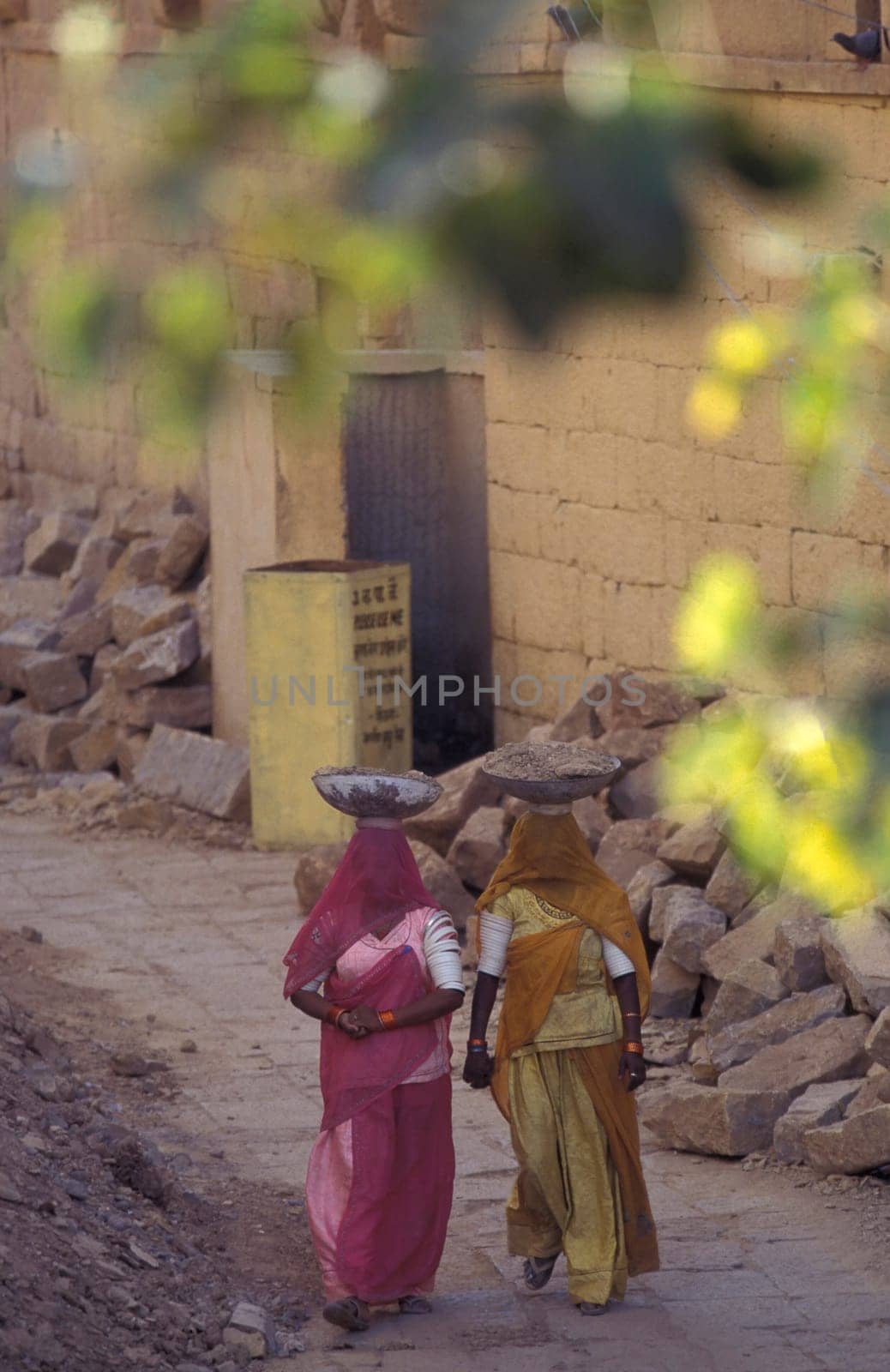 two Rajasthani women at a construction work in the Town of Jaisalmer in the Province of Rajasthan in India.  India, Jaisalmer, January, 1998