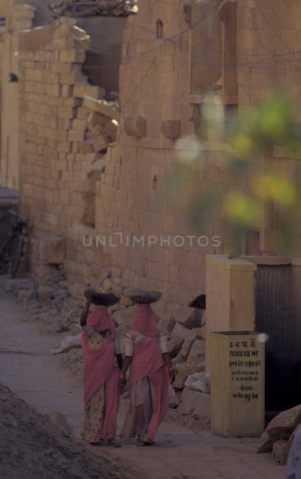 two Rajasthani women at a construction work in the Town of Jaisalmer in the Province of Rajasthan in India.  India, Jaisalmer, January, 1998