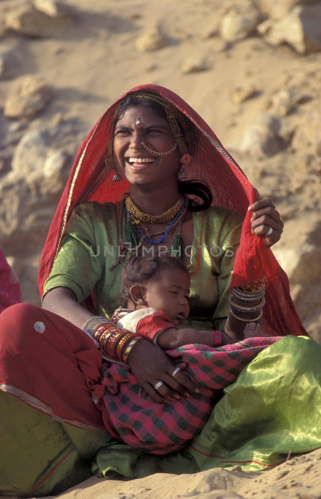 a portrait of a Rajasthani women with her Baby in the Town of Jaisalmer in the Province of Rajasthan in India.  India, Jaisalmer, January, 1998