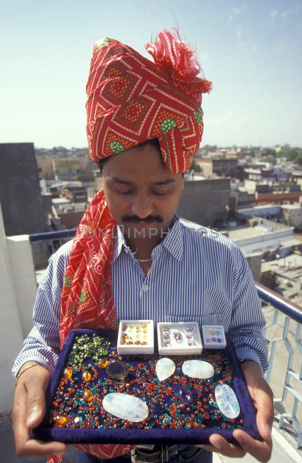 The Boss of a  Gemstone Trading company and Factory of gemstone cutting in the City of Jaipur in the Province of Rajasthan in India.  India, JAIPUR, January, 1998