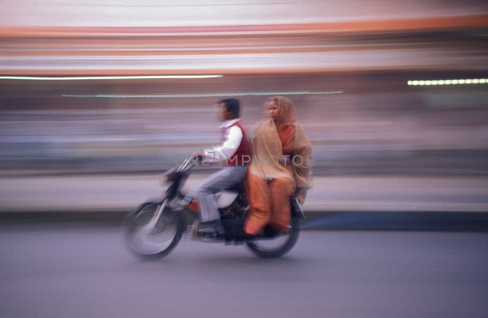 a Motorbike  traffic on a road in the City of Jaipur in the Province of Rajasthan in India.  India, Jaipur, January, 1998